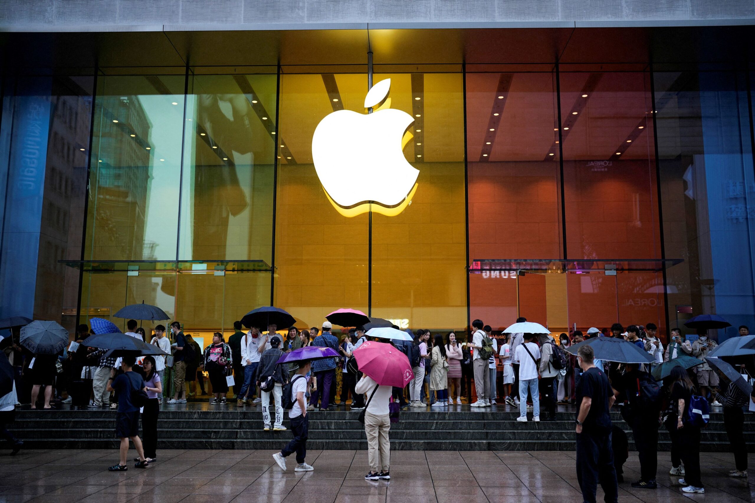People stand outside an Apple Store as Apple's new iPhone 15 officially goes on sale across China, ...