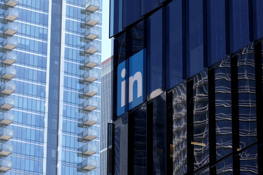 A sign is posted on the exterior of a LinkedIn office on July 26 in San Francisco, California. Link...