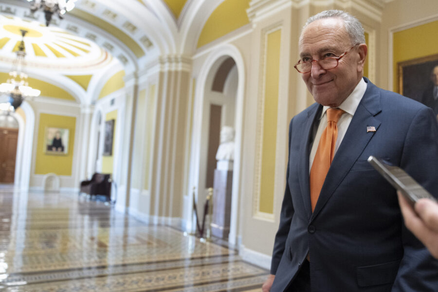 Senate Majority Leader Chuck Schumer of N.Y., walks into a closed-door caucus meeting after the Hou...