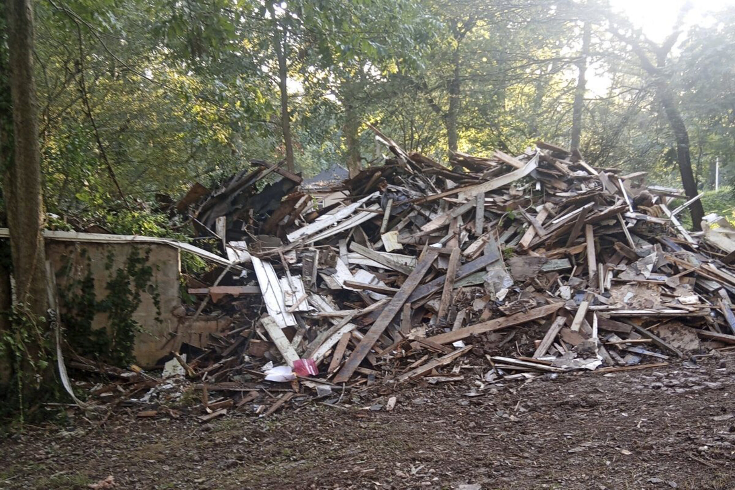 In this photo provided by Susan Hodgson, her mistakenly demolished family home sits in a pile of lu...