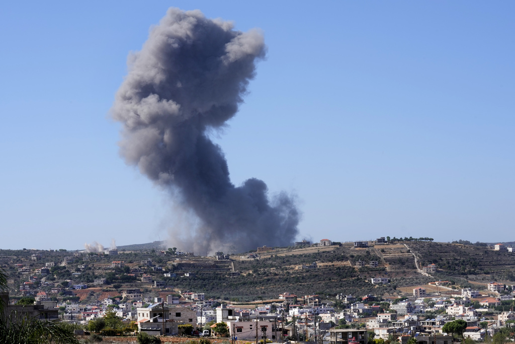 Black smoke rises from an Israeli airstrike on the outskirts of Aita al-Shaab, a Lebanese border vi...