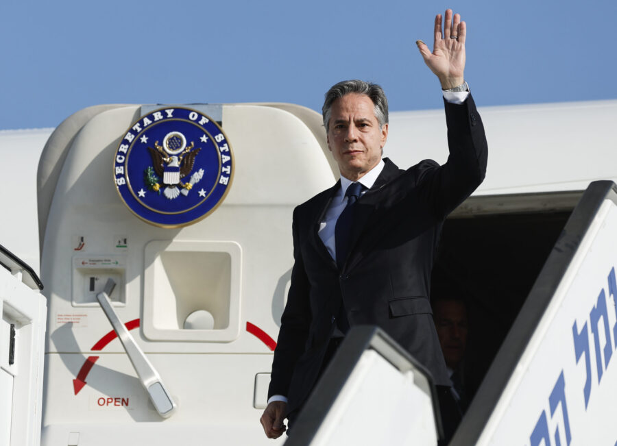 U.S. Secretary of State Antony Blinken waves as he disembarks from an aircraft on his arrival in Te...