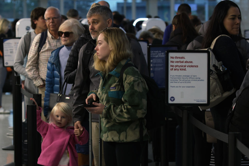 Passengers wait in-line for going through security check at Ronald Reagan Washington National Airpo...