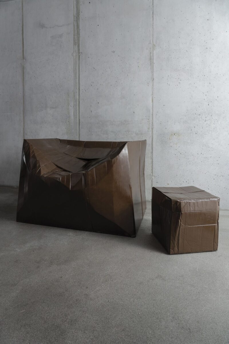 Illya Goldman Gubin strengthens misshapen cardboard boxes using resin and fiberglass. (Phillip Koll, CNN)