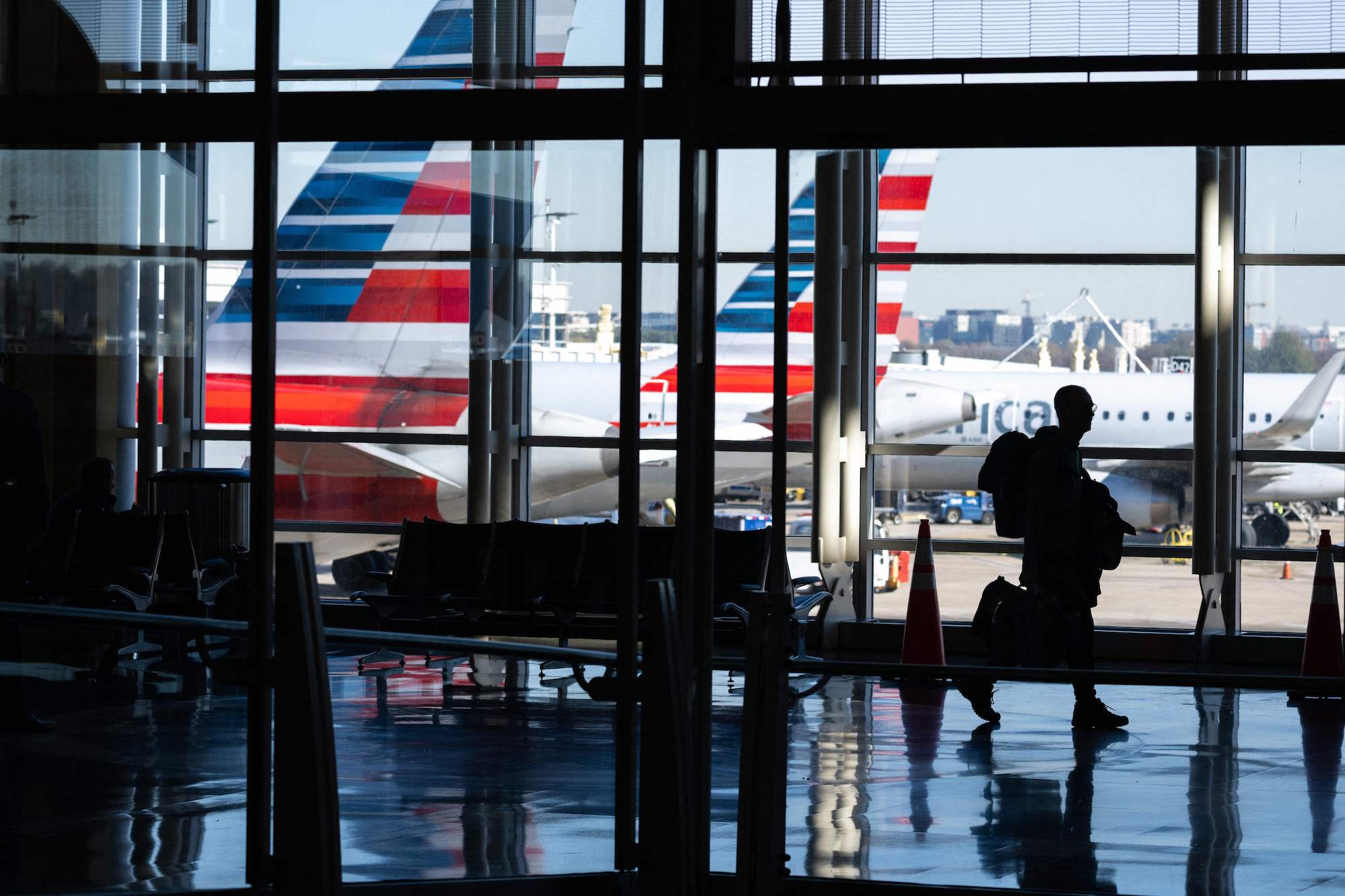 A traveler walks through Ronald Reagan National Airport in Arlington, Virginia, in November 2022, a...