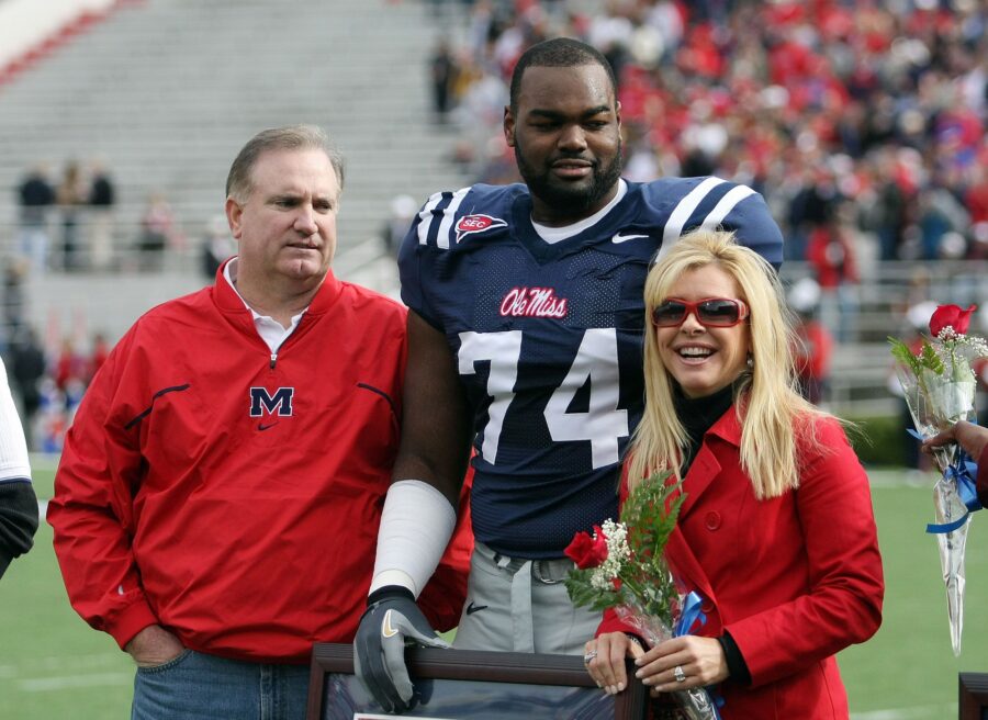 Michael Oher (center) stands with Sean and Leigh Anne Tuohy prior to a game between Ole Miss and Mi...