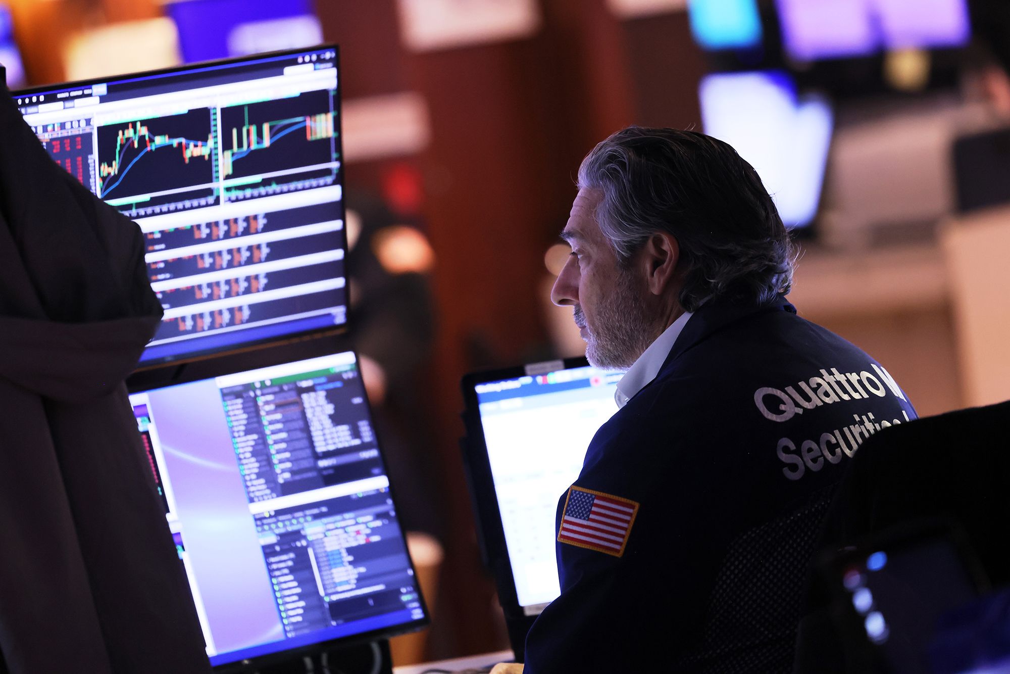 Traders work on the floor of the New York Stock Exchange during afternoon trading on September 26 i...