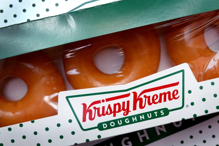 Krispy Kreme is giving away a box of a dozen glazed donuts for free with no purchase necessary to t...