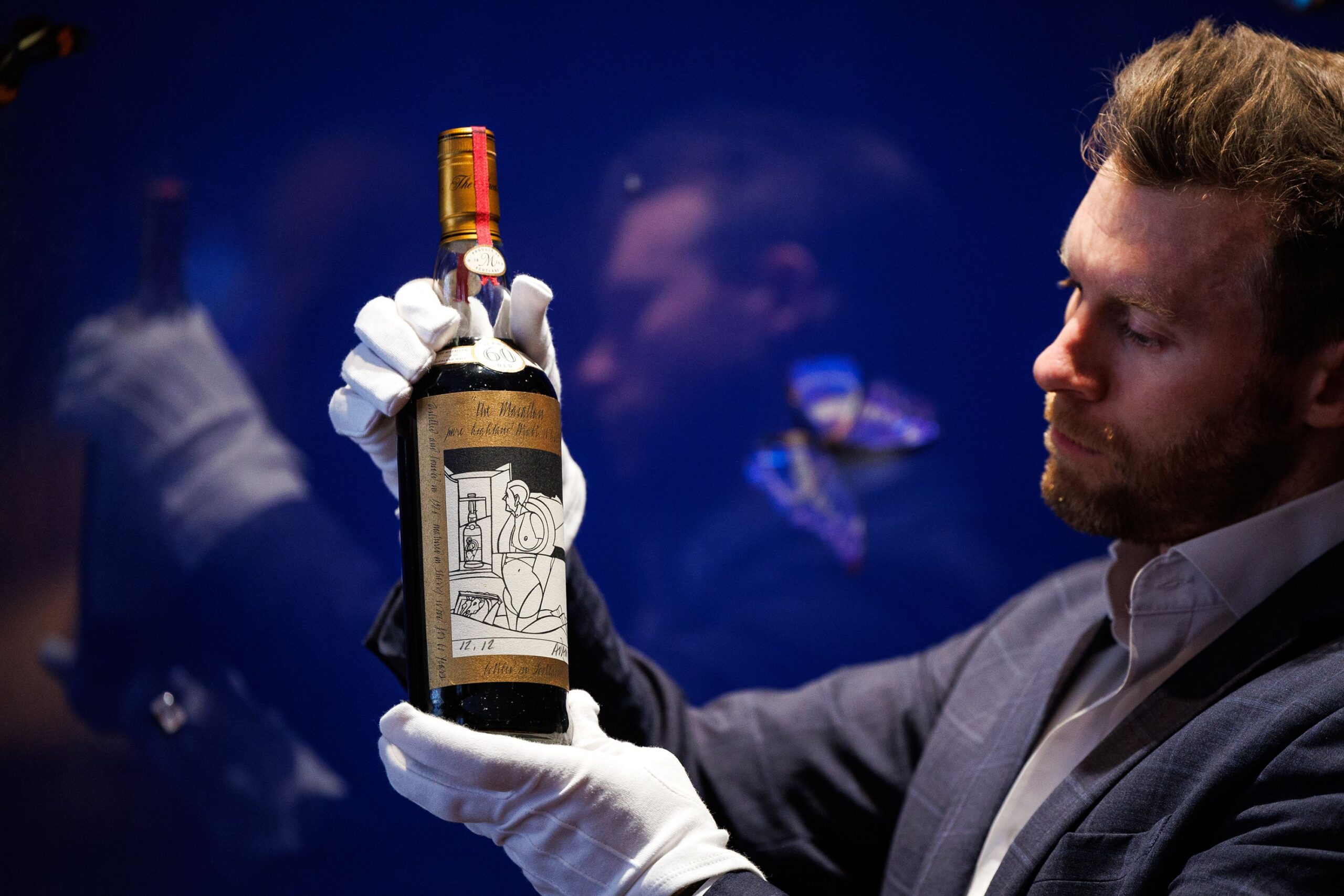 Jonny Fowle, Sotheby's global head of whisky, unveils a bottle of The Macallan 1926, the world's mo...
