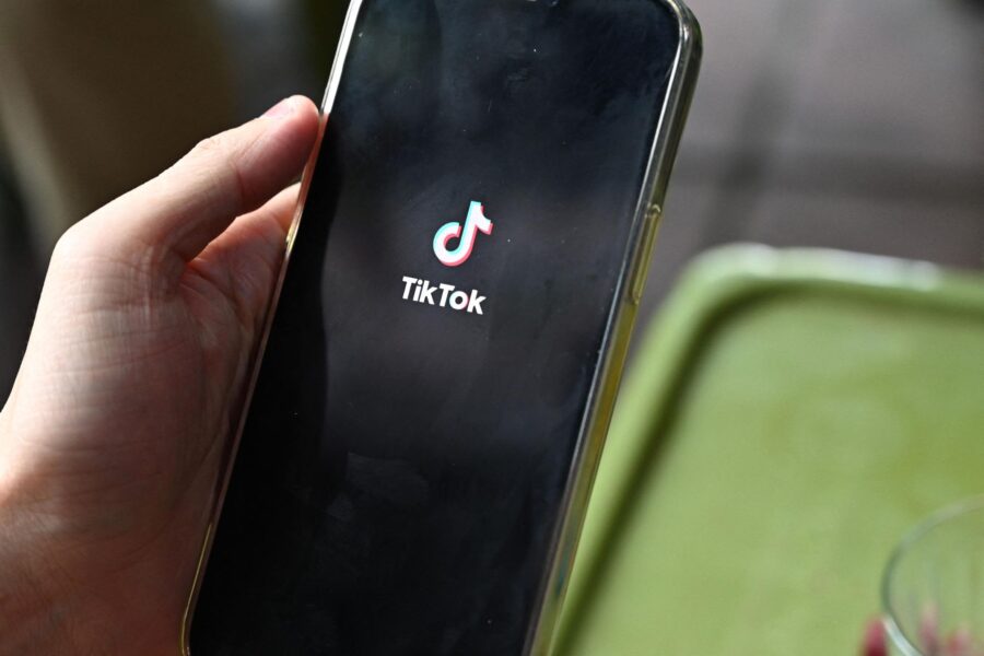 The logo of the social media platform TikTok is displayed on a mobile phone in Hanoi on October 6. ...