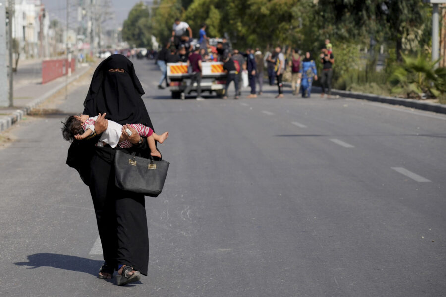 Palestinians flee the southern Gaza Strip on Salah al-Din street in Bureij on Sunday, Nov. 5, 2023....