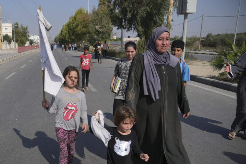 Palestinians flee the southern Gaza Strip on Salah al-Din street in Bureij on Sunday, Nov. 5, 2023. (Hatem Moussa, Associated Press)