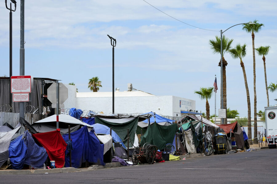 Tents line the street of "The Zone," a homeless encampment, Tuesday, July 11, 2023, in Phoenix.  Th...