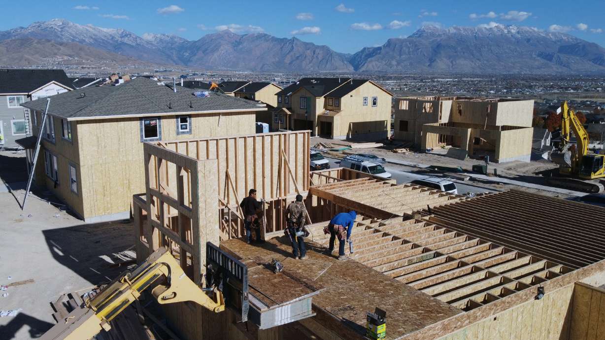 Workers construct single-family homes in Saratoga Springs Nov. 14. Utah gained close to 56,000 new ...