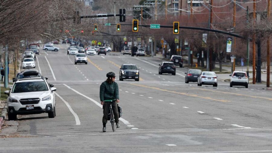 A cyclist watches traffic before crossing 400 East at 200 South in Salt Lake City on Tuesday, March...