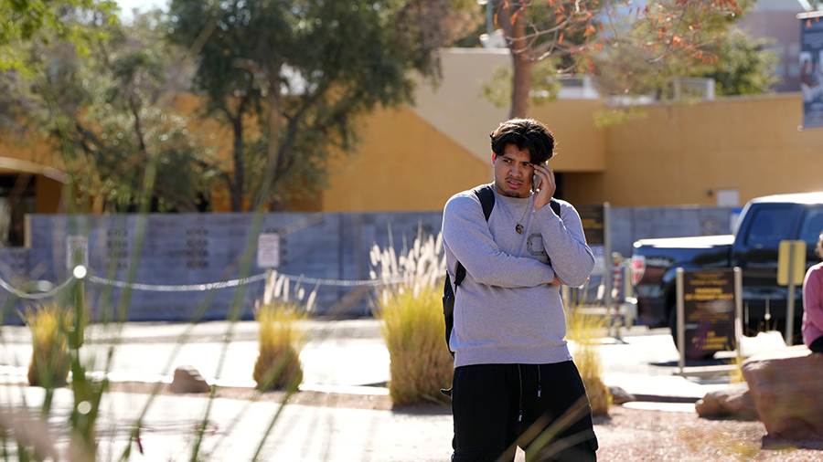 A University of Nevada, Las Vegas, student talks on his cellphone after a shooting reported on camp...
