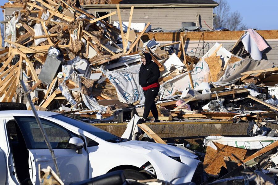 Amber Gardner looks at the debris from a friend's destroyed house in the West Creek Farms neighborh...