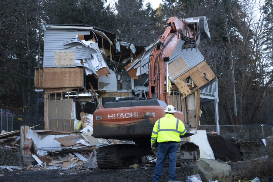 Heavy equipment is used to demolish the house where four University of Idaho students were killed i...