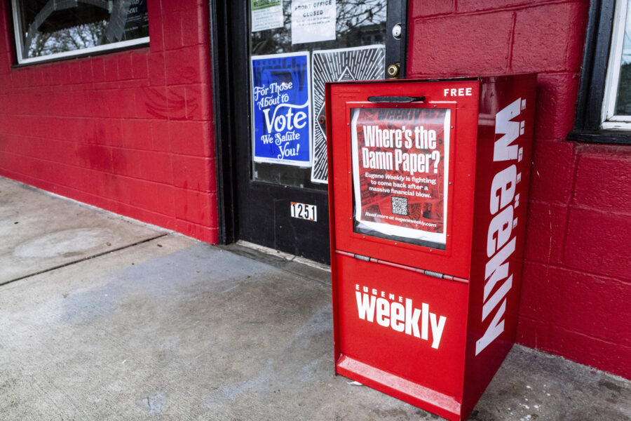 A red Eugene Weekly newspaper distributor box stands outside its office in Eugene, Ore. on Friday, ...