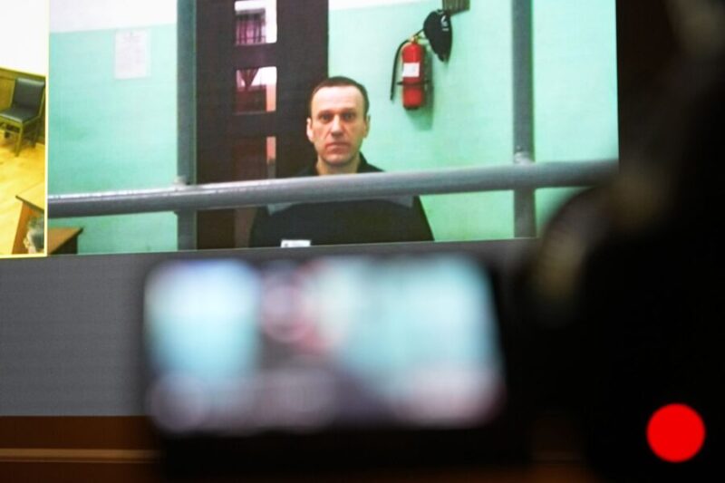 Alexei Navalny is seen on a TV screen as he appears by video link at a court hearing in Moscow on June 22, 2023. (Alexander Zemlianichenko, Associated Press)