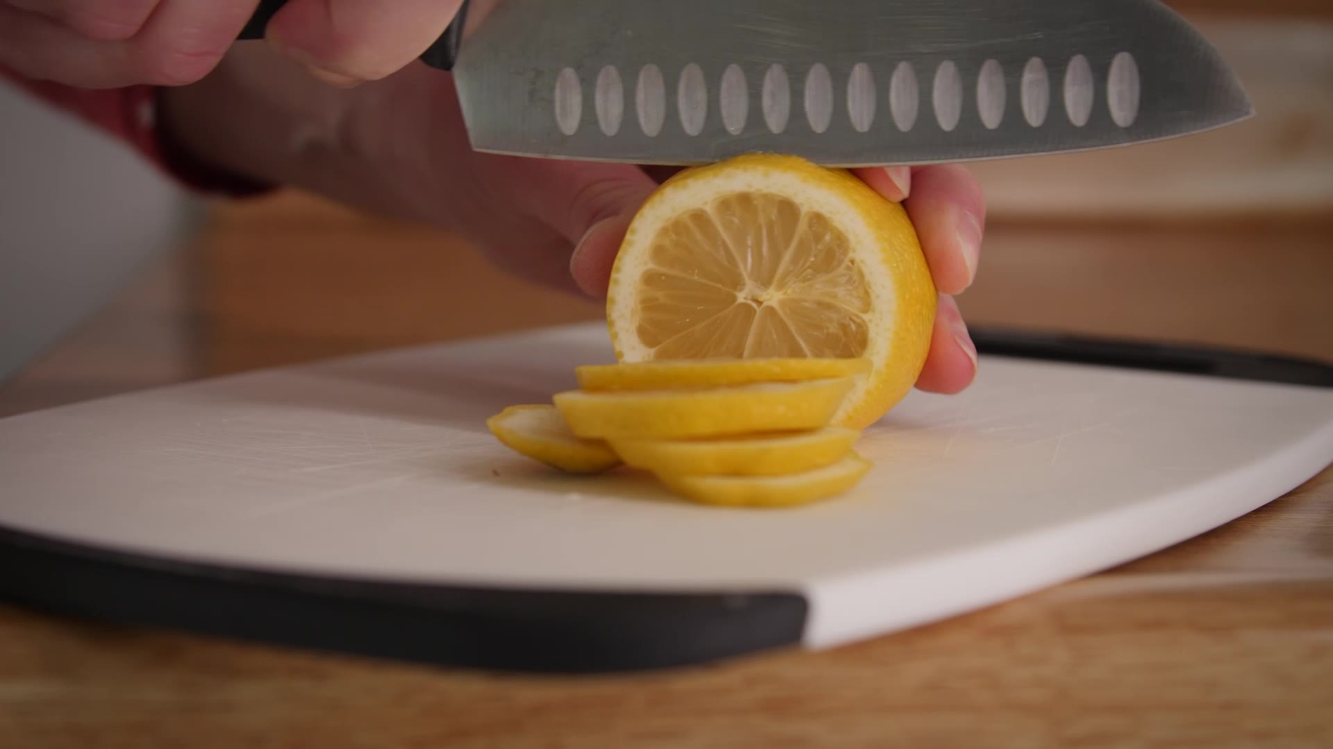 (FILE) - A person cutting a lemon....