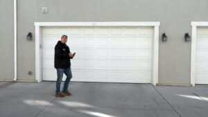 Matt walks in front of garage