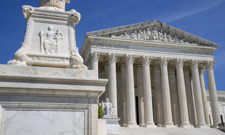 FILE - The U.S. Supreme Court is seen, with a carving of Justice in the foreground, April 19, 2023,...
