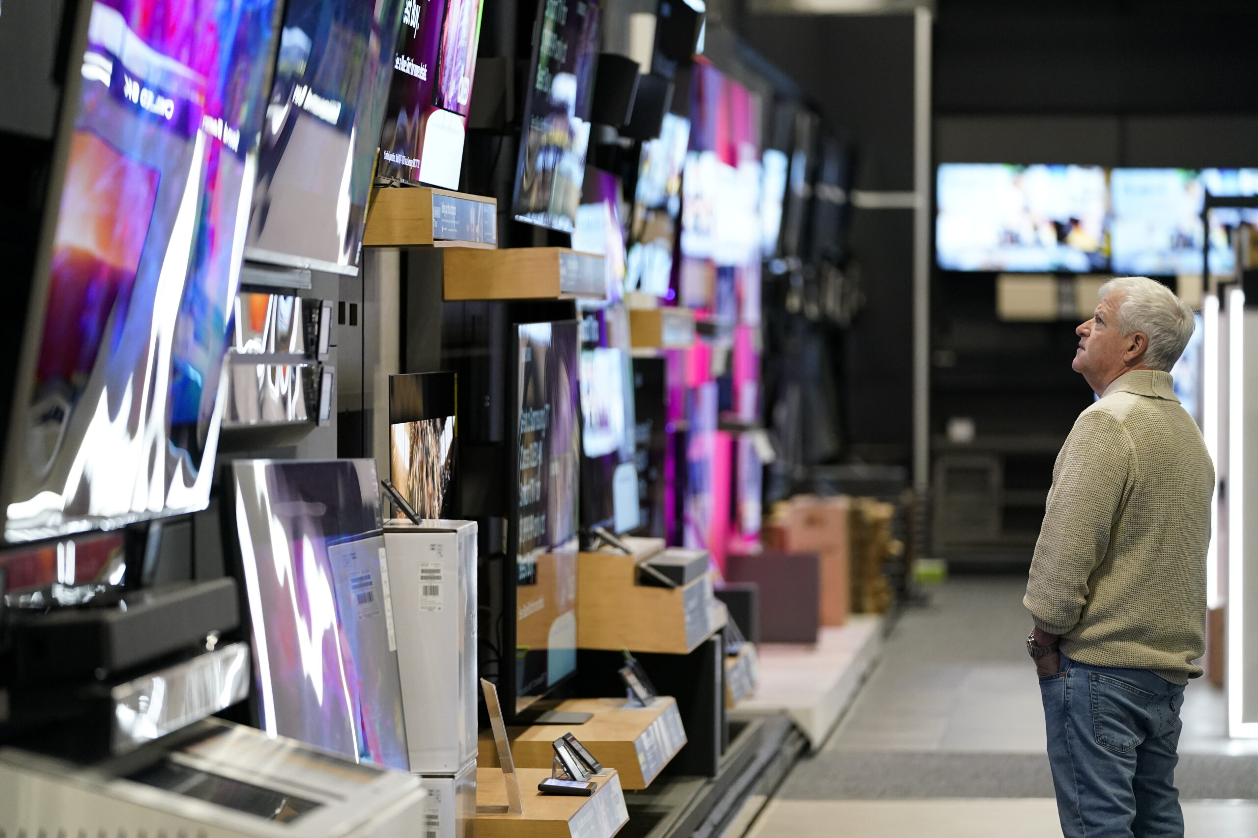 FILE - A customer browses televisions at a Best Buy store on Black Friday, Friday, Nov. 24, 2023, i...