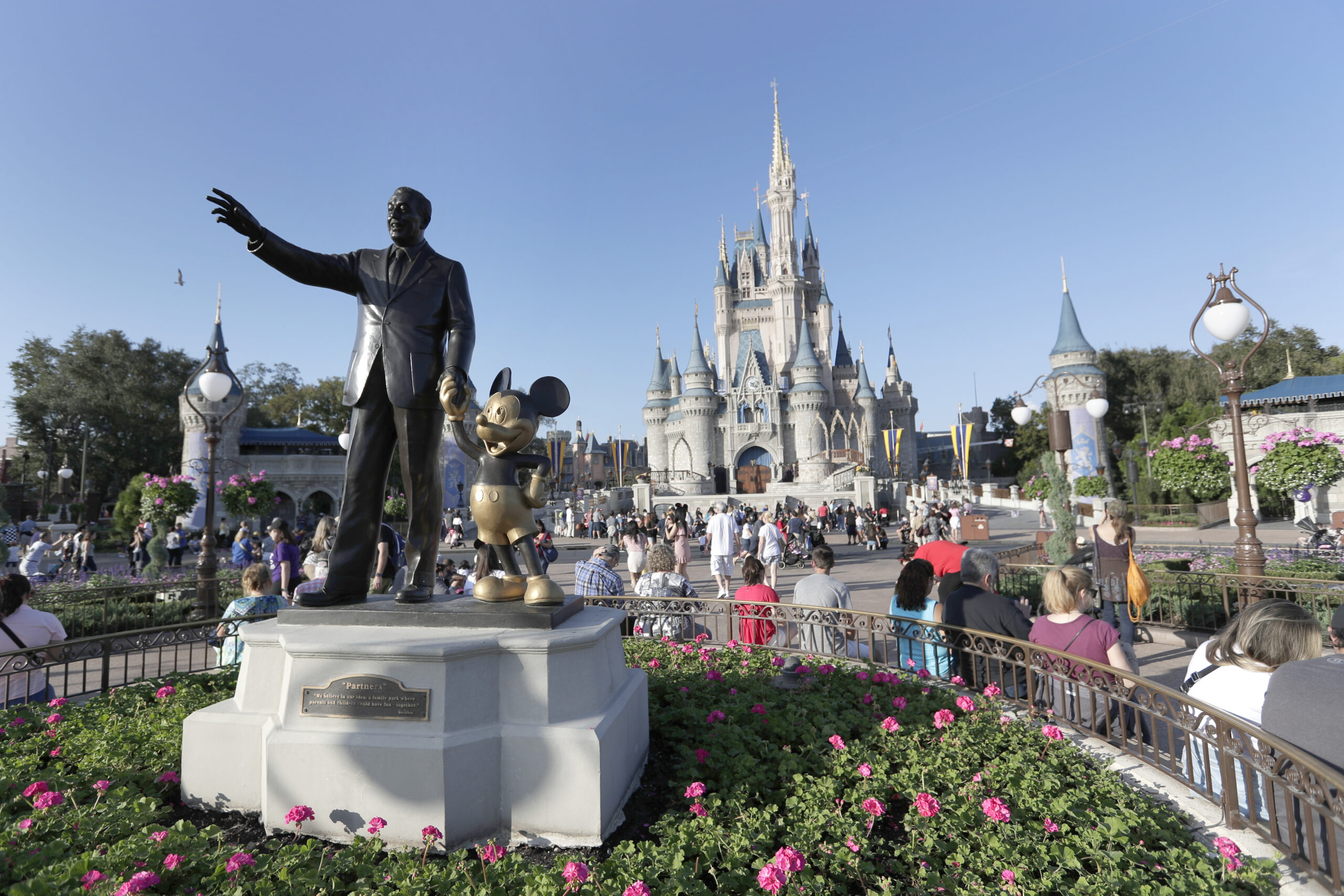 FILE - A statue of Walt Disney and Mickey Mouse appears in front of the Cinderella Castle at the Ma...