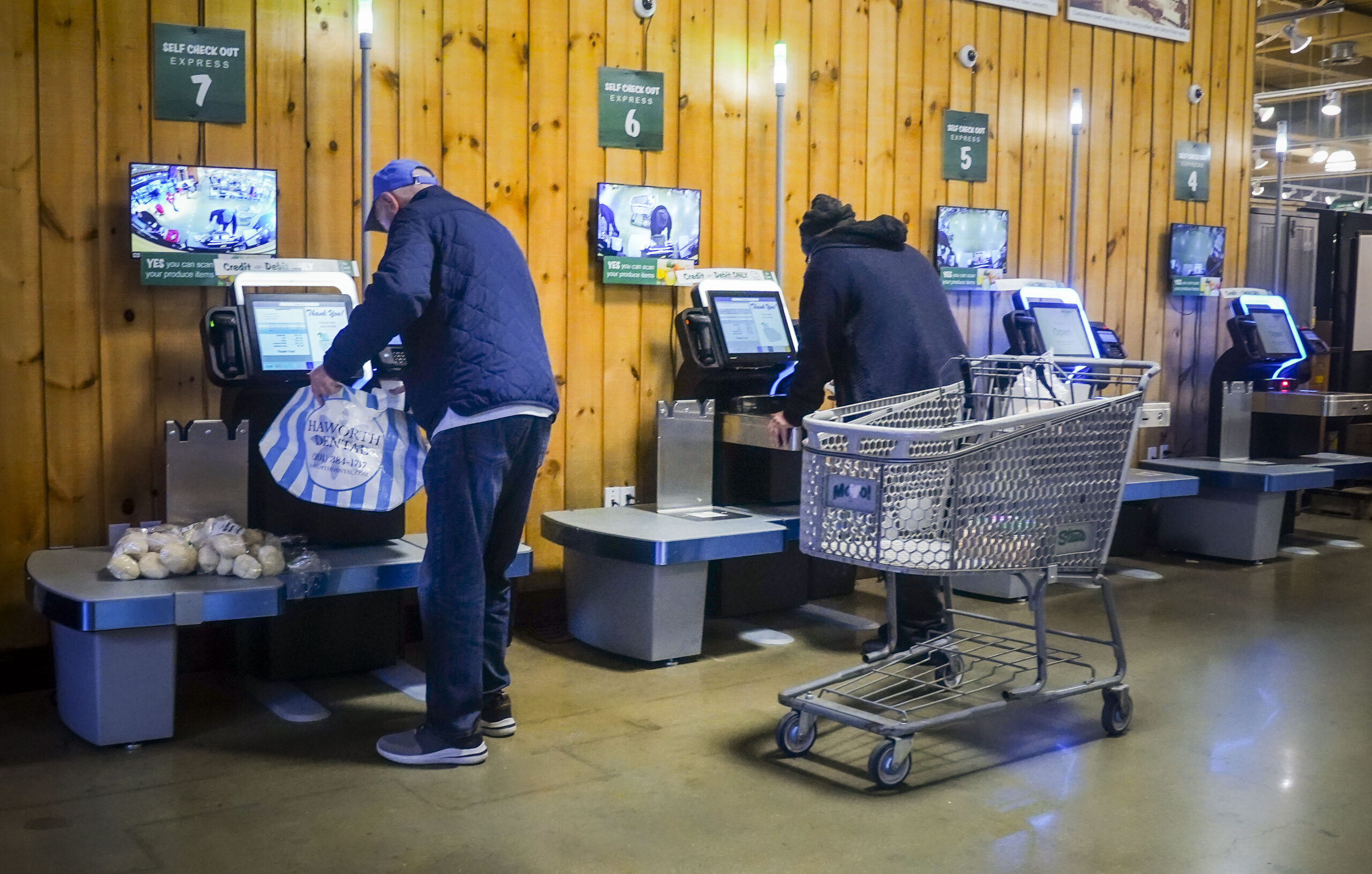 Customers use self-checkout kiosks at Stew Leonard's grocery store in Paramus, N.J., Wednesday, Dec...