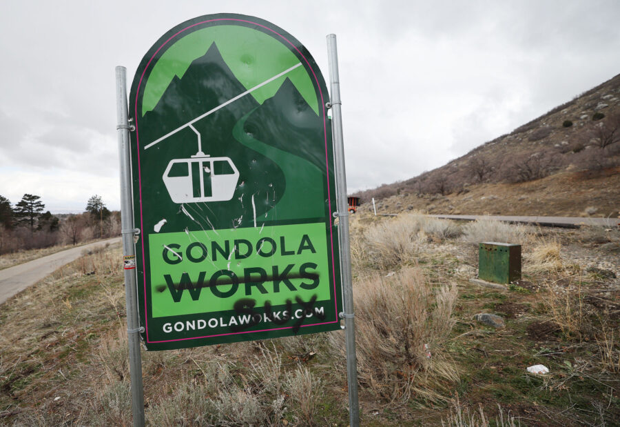 A Gondola Works sign that has graffiti on it in is pictured near Little Cottonwood Canyon on Wednes...