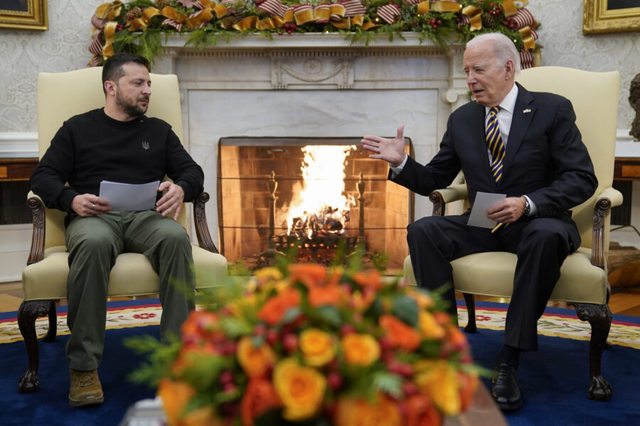 FILE - President Joe Biden reaches out to shake hands with Ukrainian President Volodymyr Zelenskyy ...