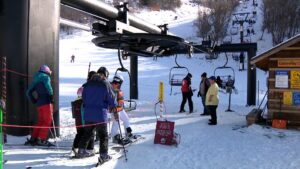 Skiers and snowboarders at the Cherry Peak Resort.