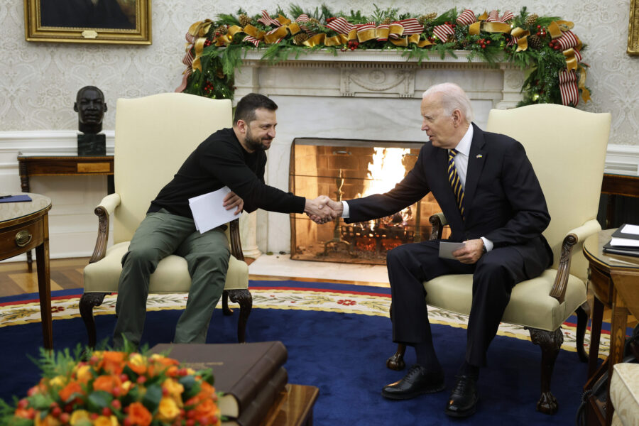 Ukrainian President Volodymyr Zelensky (L) and U.S. President Joe Biden shake hands while meeting i...