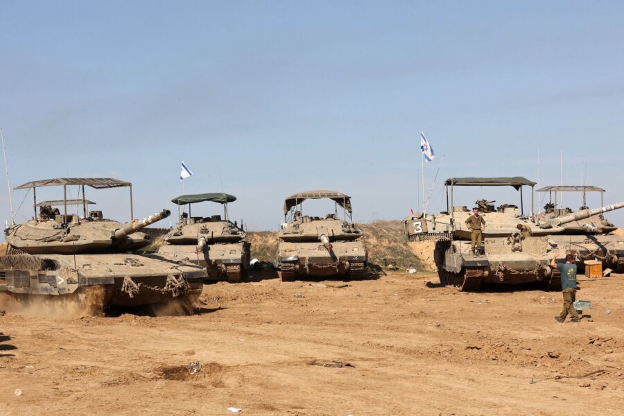 Israeli troops gather with their military vehicles on the border with the Gaza Strip on November 30...