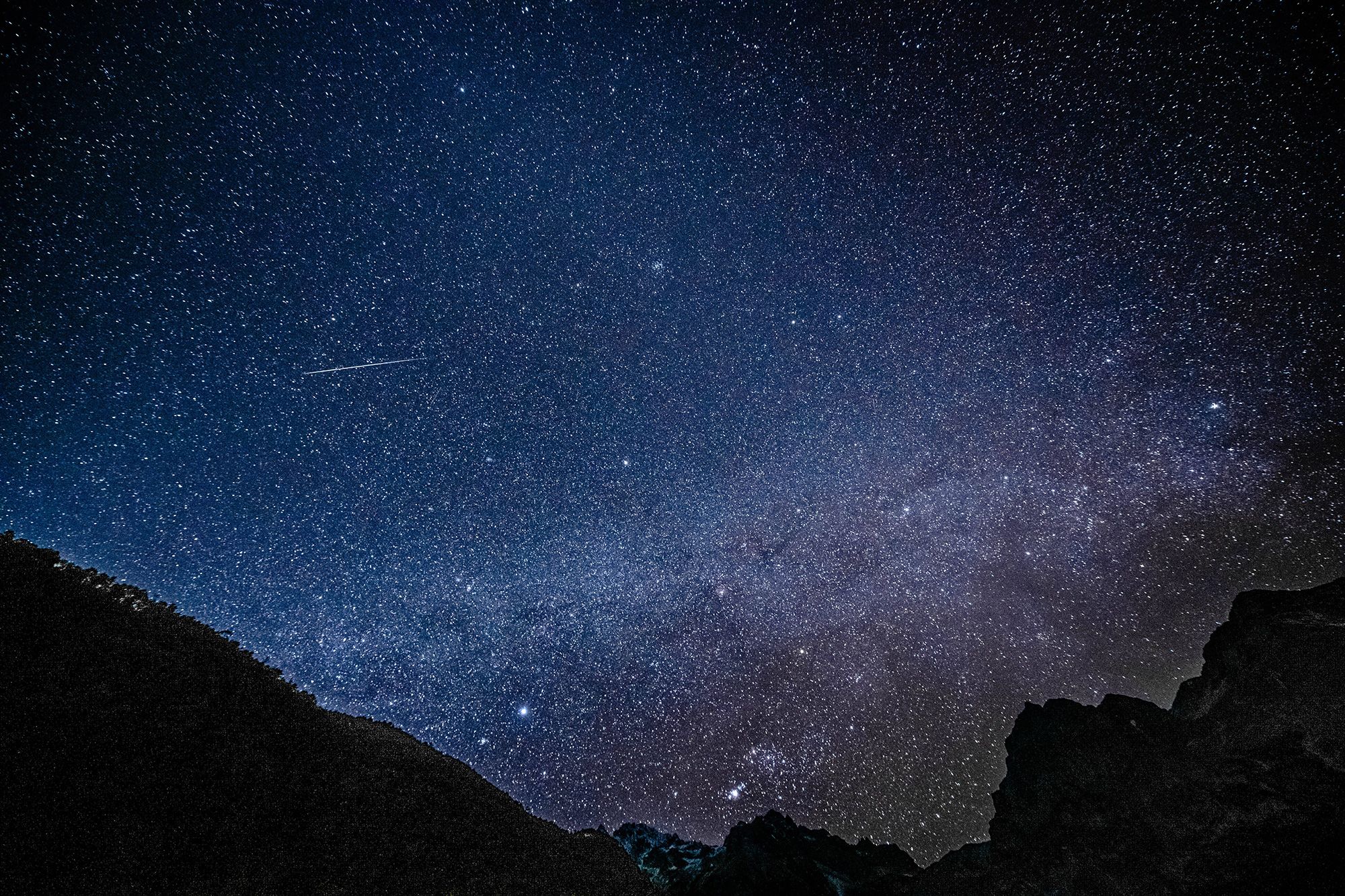 A Geminid meteor is seen streaking across the sky at the Yulong Snow Mountain in southwest China in...
