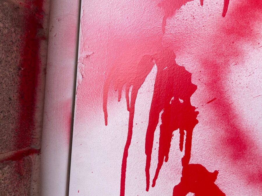 A close up photo of red spray paint written on a Salt Lake City elementary school on Sunday, Dec. 1...