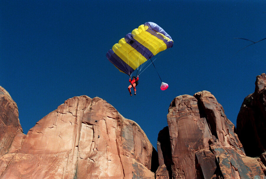Sue Runyon glides toward target during cliff jumping in moab area february 26, 1999. (Ravell Call, ...