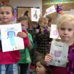 Children in Mrs. Bradshaw's kindergarten class at Knowlton Elementary School  show their monster designs. (KSL TV)