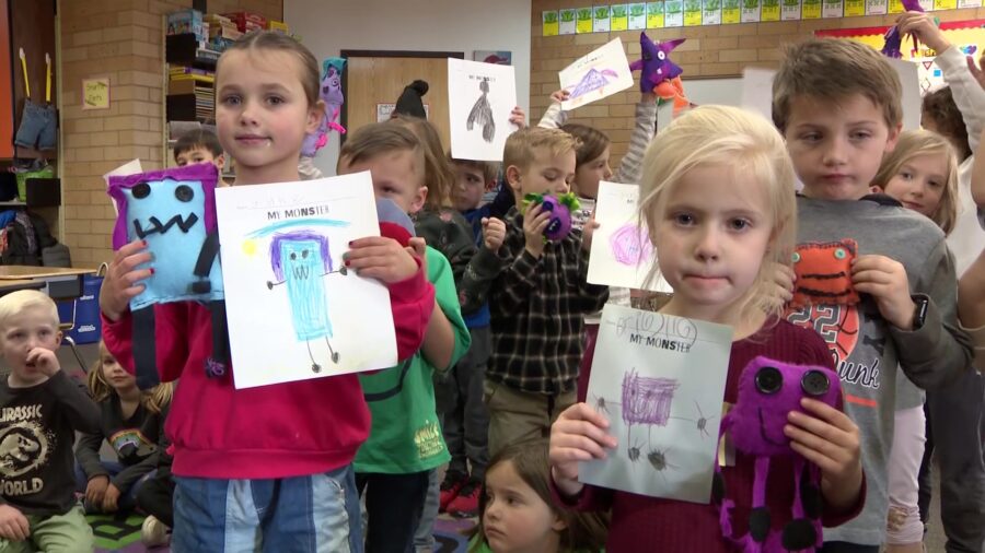 Children in Mrs. Bradshaw's kindergarten class at Knowlton Elementary School  show their monster de...
