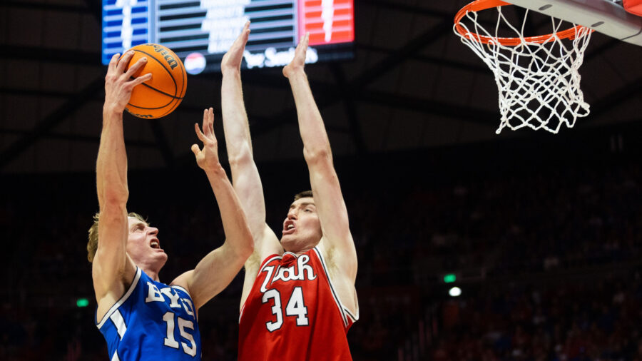 Brigham Young Cougars guard Richie Saunders (15) shoots the ball over Utah Utes center Lawson Lover...