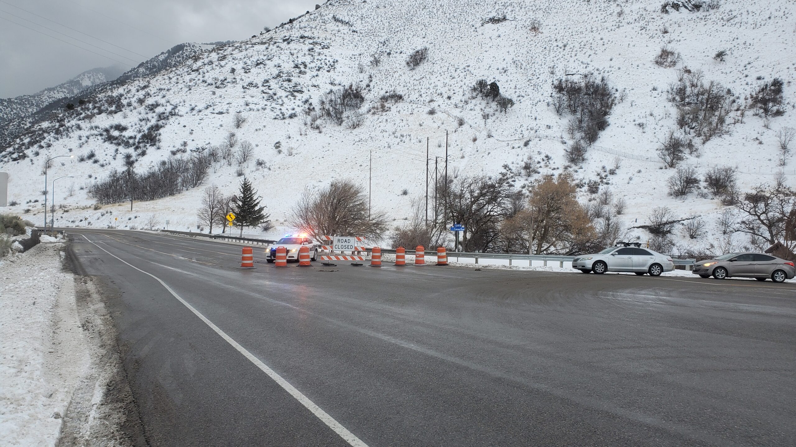 Police cars block U.S. Highway 89 in Logan Canyon following an avalanche....