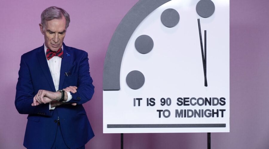 Science educator Bill Nye, looks at his watch next to the "Doomsday Clock," shortly before the Bull...