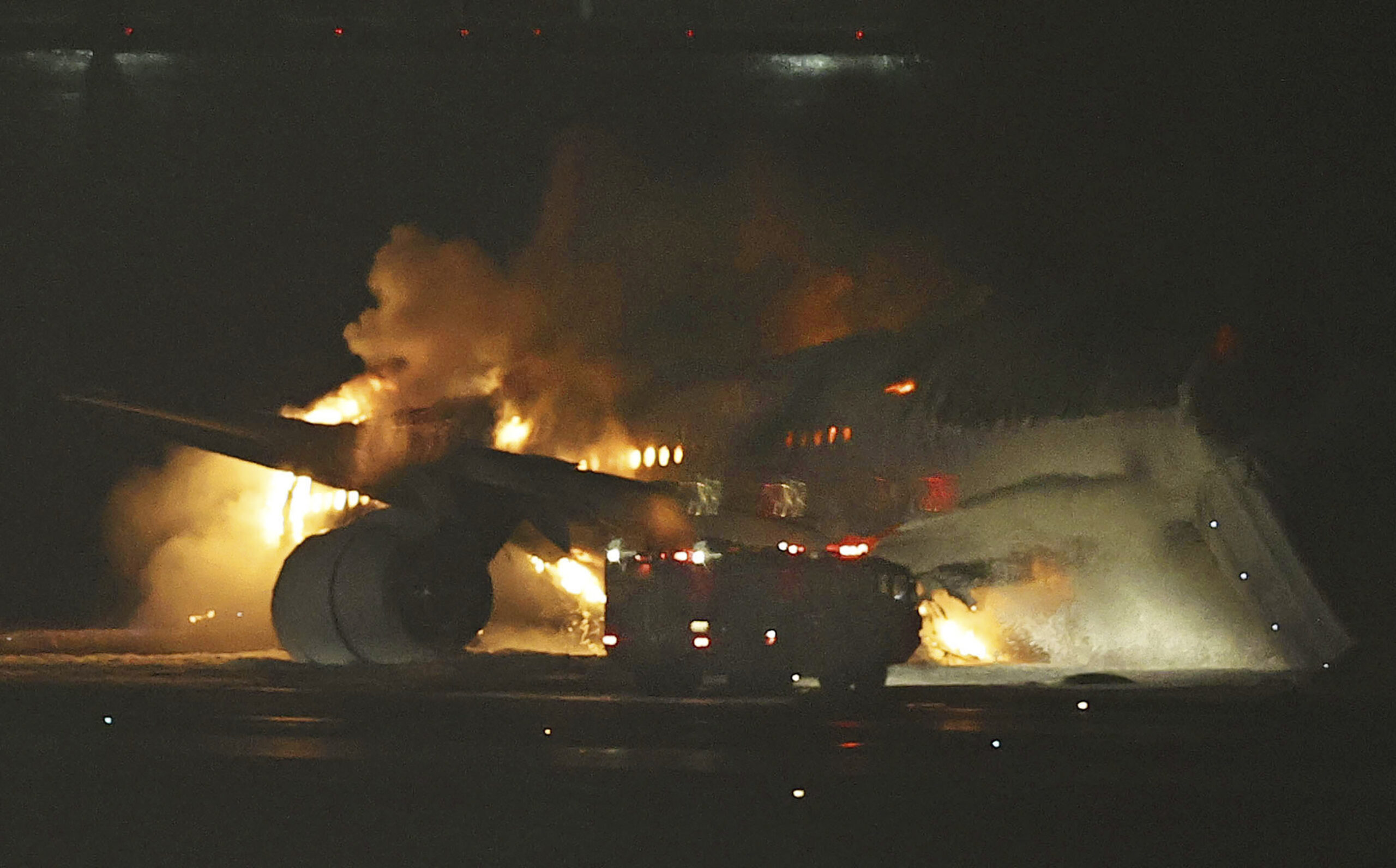 A Japan Airlines plane is on fire on the runway of Haneda airport on Tuesday, Jan. 2, 2024 in Tokyo...