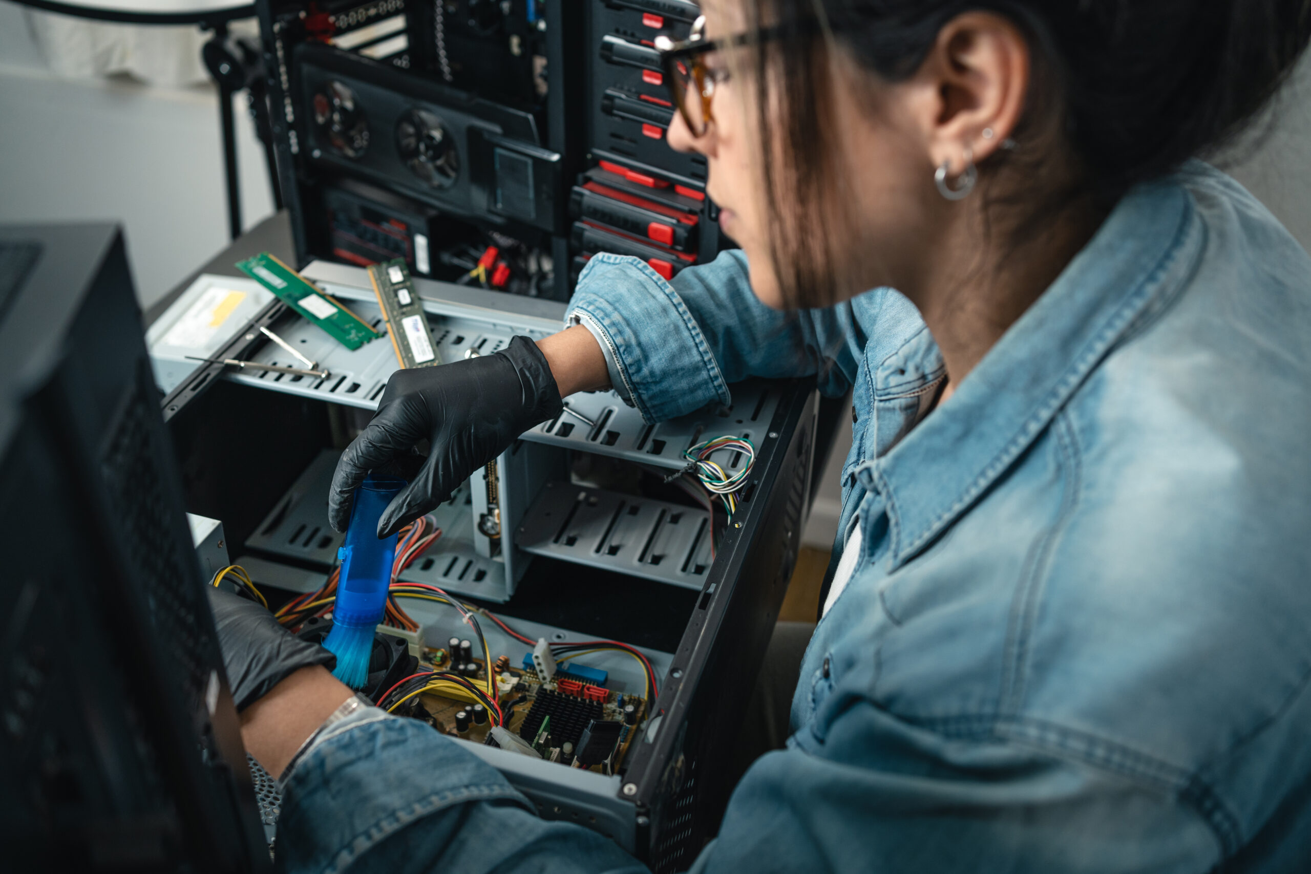 Technician woman fixing hardware of desktop computer. Close up....