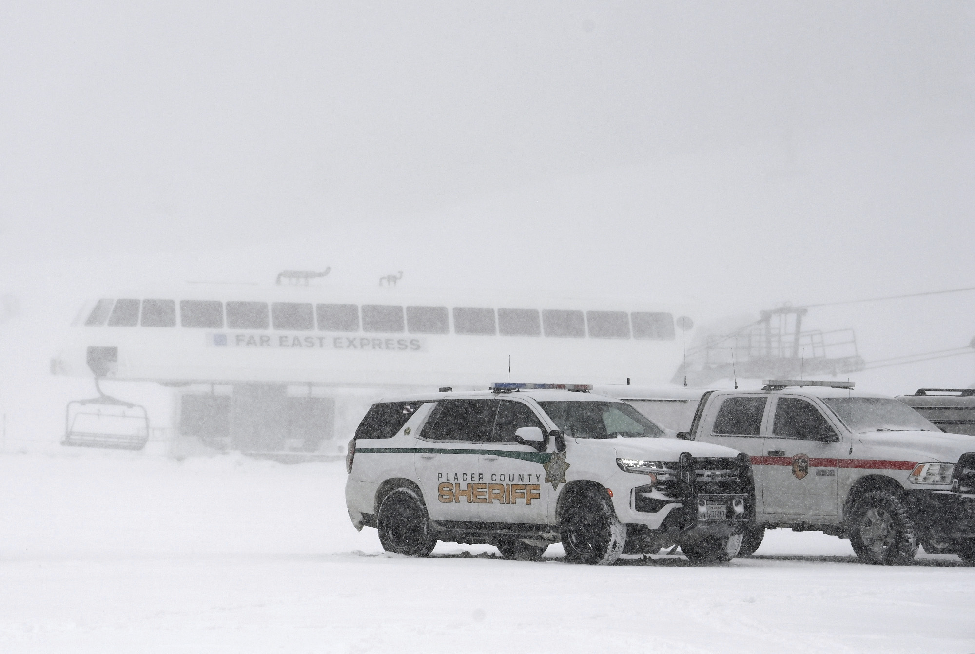 Placer County sheriff vehicles are parked near the ski lift at Palisades Tahoe where avalanche occu...