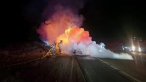 Fire fighters put out Hopkinson's car fire on Highway 189 in Wyoming on January 2