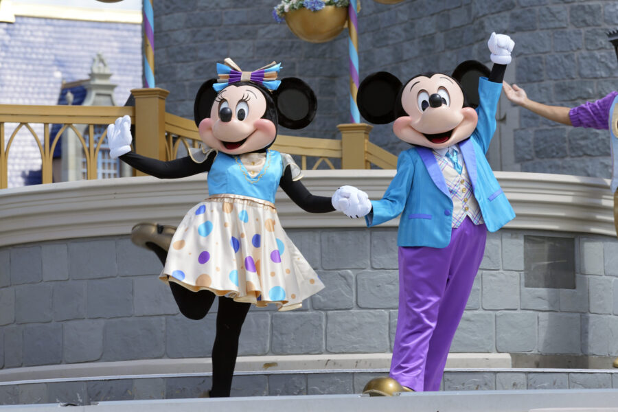FILE - Minnie and Mickey Mouse perform for guests during a musical show in the Magic Kingdom at Wal...