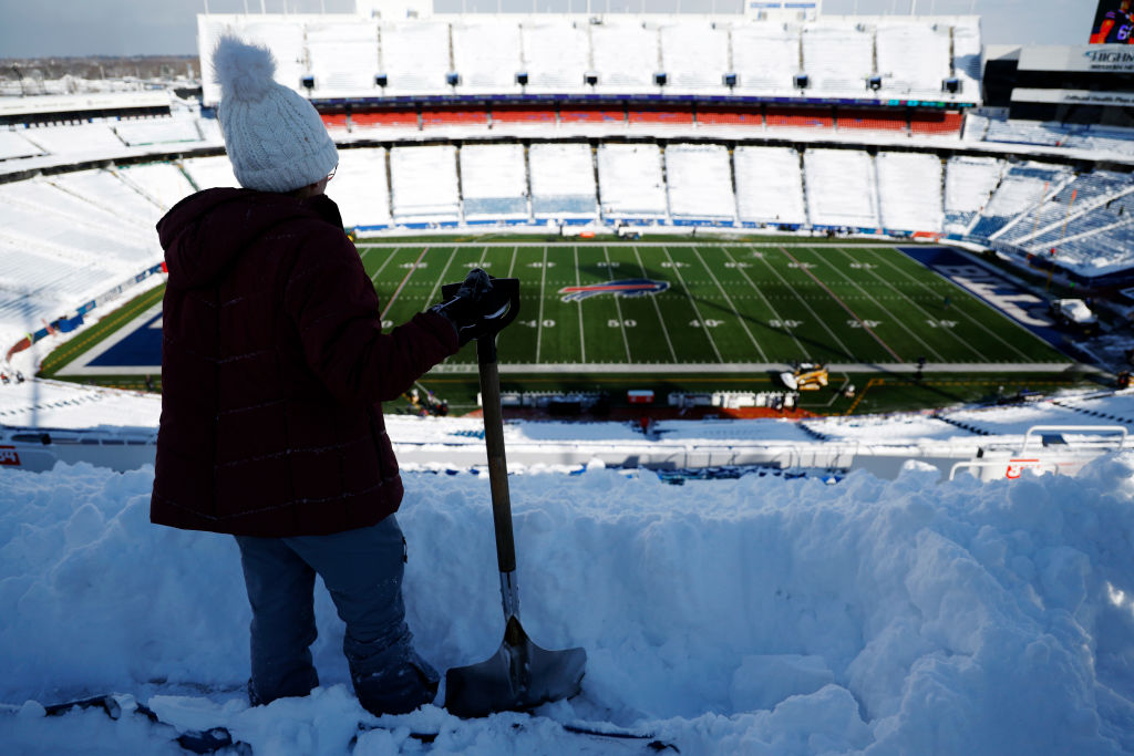 ORCHARD PARK, NEW YORK - JANUARY 15: Joanne Campbell shovels snow before the AFC Wild Card playoff ...