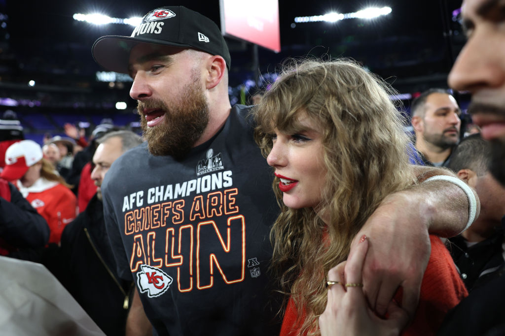 Travis Kelce #87 of the Kansas City Chiefs celebrates with Taylor Swift after a 17-10 victory again...